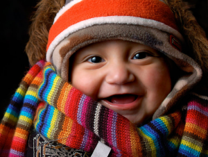 a baby wearing a piece of shawl